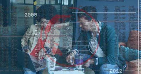 Colleagues collaborating on digital strategy in office lounge