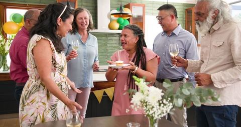 Diverse Senior Friends Celebrating Birthday Together Indoors