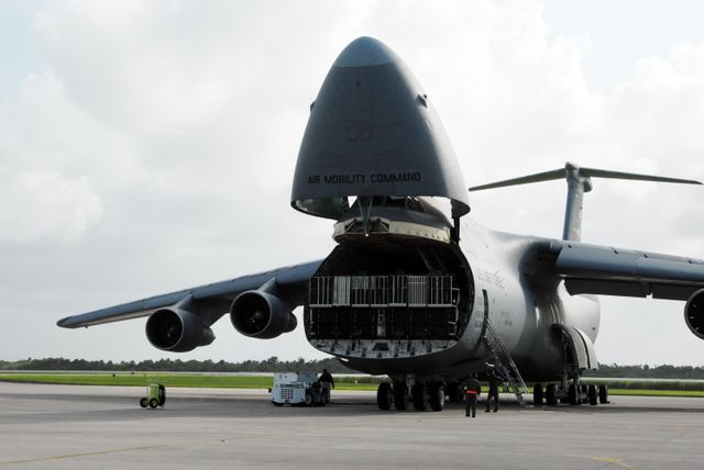 The U.S. Air Force C-5 is positioned at Kennedy Space Center's Shuttle Landing Facility for the offloading of the Express Logistics Carrier 4 (ELC4). Critical spare components intended for the International Space Station (ISS) are being delivered. This specific scene is relevant for showcasing aerospace logistics, space missions, or depicting operational aspects of NASA facilities. Useful for educational content about space shuttle missions, military-air logistics, and NASA’s activities in the early 2010s.