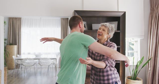 Happy caucasian mother and adult son embracing in living room - Download Free Stock Photos Pikwizard.com