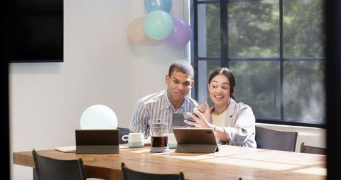 Business team celebrating birthday in modern office environment