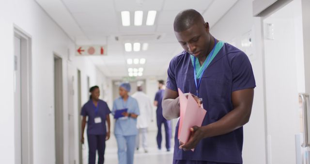 Healthcare Professional Reviewing Patient Records in Hospital Corridor - Download Free Stock Images Pikwizard.com