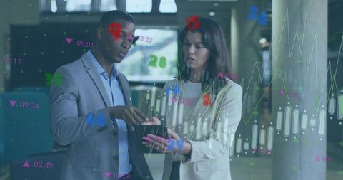 Business professionals analyzing financial data on tablet with stock market charts overlay