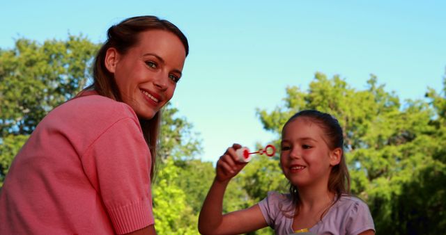 Mother and Daughter Enjoying Summer Day Blowing Bubbles - Download Free Stock Images Pikwizard.com