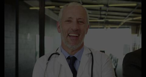 Experienced doctor smiling in modern clinic setting