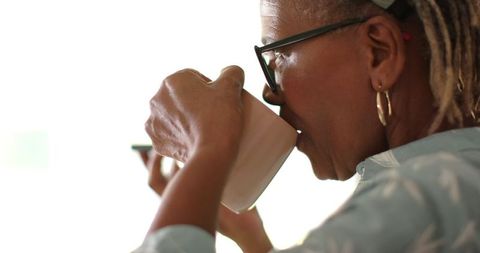 Senior Woman Enjoying Coffee in Morning Light