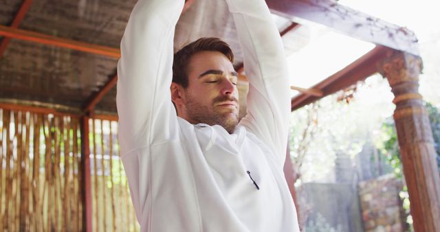 Caucasian man practicing yoga and meditating at vacation home. active and healthy lifestyle during vacation concept