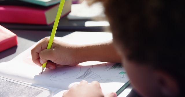 Child Drawing with Bright Yellow Pencil on Notepad - Download Free Stock Images Pikwizard.com