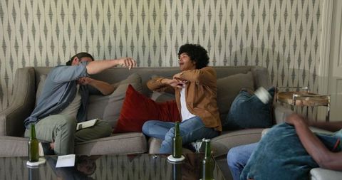 Friends Enjoying Conversation on Comfortable Couch During Cozy Home Gathering