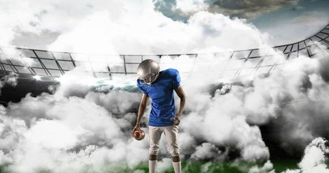 American Football Player in Cloudy Stadium Holding Ball