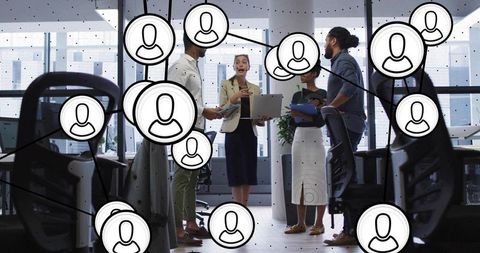 Diverse business team collaborating in open-plan office with digital network overlay