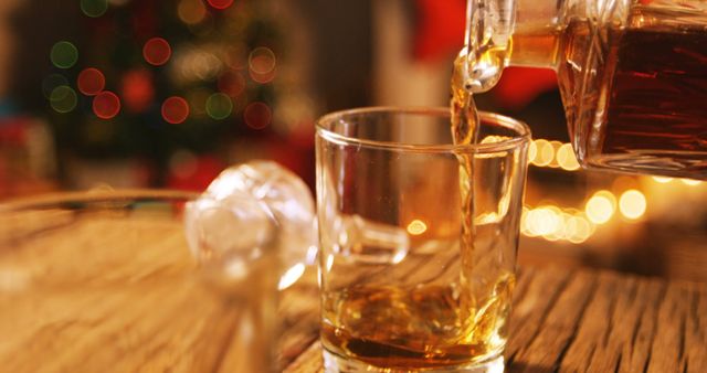 Pouring Whiskey Into Glass with Festive Background - Download Free Stock Images Pikwizard.com