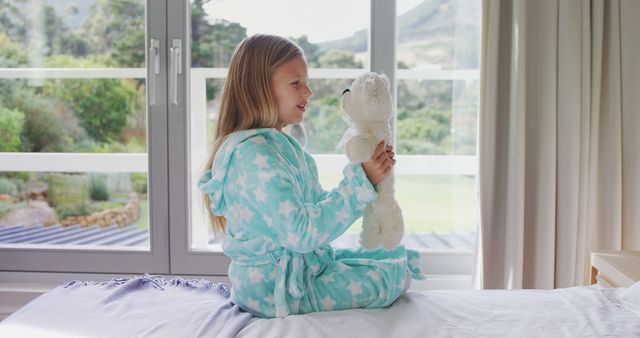 Happy Girl in Pajamas Playing with Plush Bear by Window - Download Free Stock Images Pikwizard.com