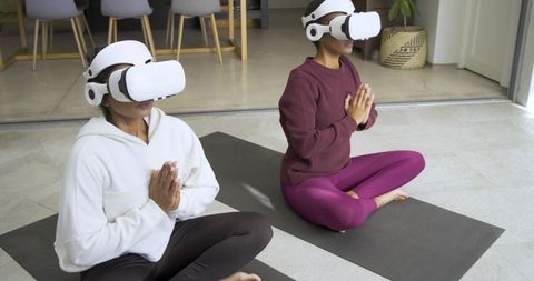Two Women Meditating with VR Headsets for Modern Mindfulness