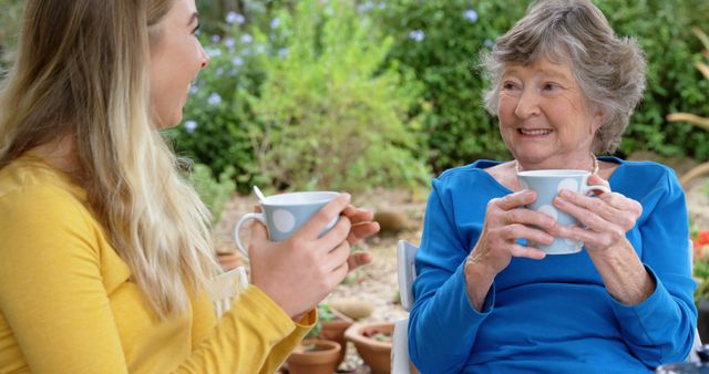 Happy senior caucasian woman and adult daughter drinking tea and talking together sitting outdoors - Download Free Stock Photos Pikwizard.com