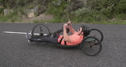 Man Riding Recumbent Bicycle on Peaceful Road