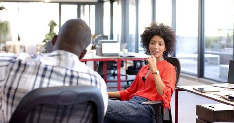 Diverse Colleagues Discuss Strategy in Relaxed Office Environment
