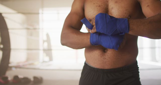 Image of midsection of fit african american man preparing for box training at gym - Download Free Stock Photos Pikwizard.com