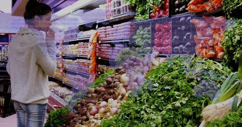 Young woman selecting fresh vegetables in vibrant supermarket aisle for healthy shopping
