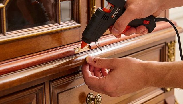 Restoring wooden dresser trim with hot glue gun, diy furniture repair close-up