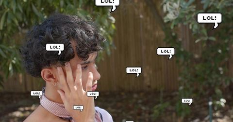 Young man touching face, gazing in backyard with pixelated lol bubbles, social media theme