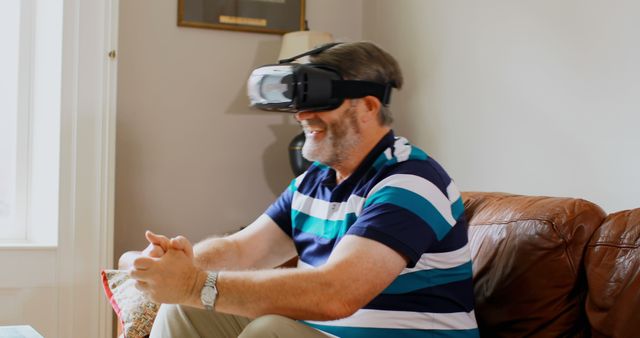 Smiling Elderly Man Experiencing Virtual Reality on Sofa - Download Free Stock Images Pikwizard.com
