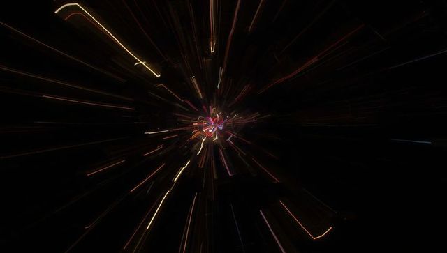 Dynamic Starburst Light Trails on Dark Background