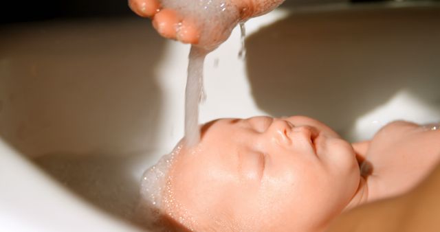 Newborn Bathing with Gentle Hand Pouring Water on Head - Download Free Stock Images Pikwizard.com