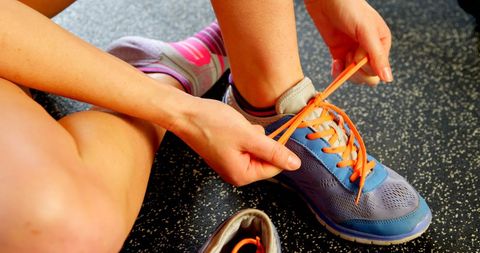 Woman Tying Shoe Laces Before Exercise - Download Free Stock Images Pikwizard.com