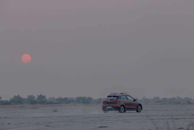 SUV Exploring Desert at Sunrise with Pink Hues - Download Free Stock Images Pikwizard.com