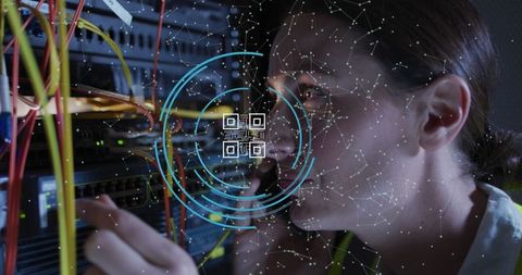 Female technician using system with qr code overlay in server room