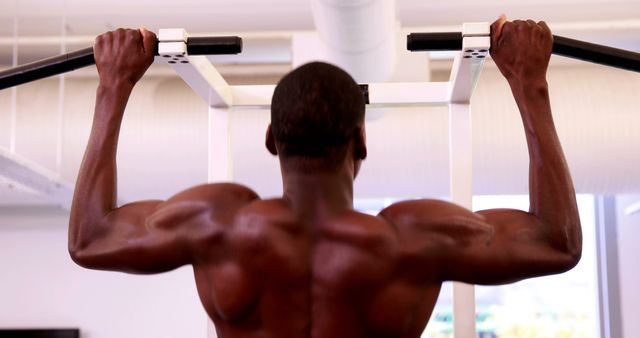 Fit shirtless man doing pull ups at the gym - Download Free Stock Photos Pikwizard.com