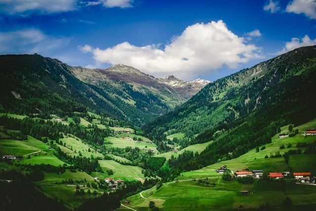 Scenic Mountain Valley with Lush Green Fields and Clear Blue Sky - Download Free Stock Photos Pikwizard.com