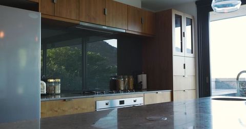 Minimalist kitchen with marble countertop and wooden cabinets