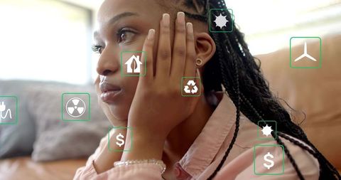 Contemplating sustainable choices resting face in hands, woman viewing ar energy icons