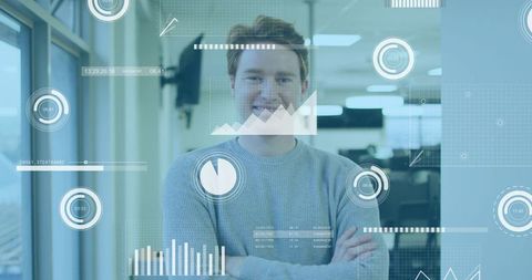 Smiling male employee crossing arms in tech office with augmented reality dashboards, kpis