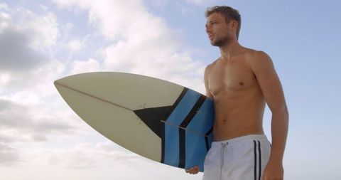 Confident Surfer Ready to Ride Waves on Sunny Day