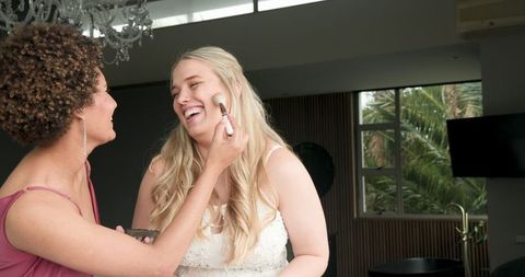 Joyful Bride and Bridesmaid Sharing Pre-Wedding Moments