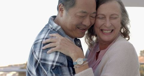 Happy Senior Couple Embracing in Tranquil Outdoor Setting