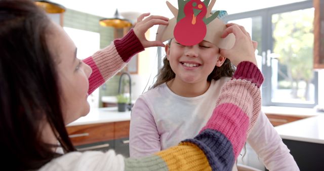 Mother Helping Child with Handmade Turkey Hat in Kitchen - Download Free Stock Images Pikwizard.com