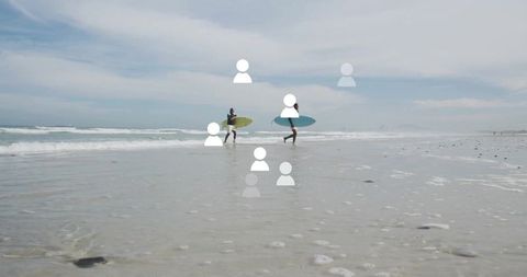 Surfers Carrying Boards Across Beach at Sunrise