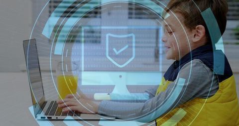 Young boy typing on laptop with cybersecurity shield protecting online learning from home