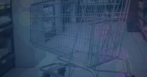 Empty shopping cart in grocery store aisle with abstract overlay