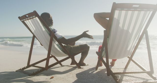 Two People Relaxing in Deck Chairs on Beach at Sunset - Download Free Stock Images Pikwizard.com