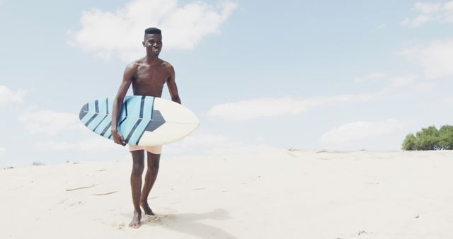 Young Surfer Carrying Surfboard on Sandy Beach - Download Free Stock Images Pikwizard.com