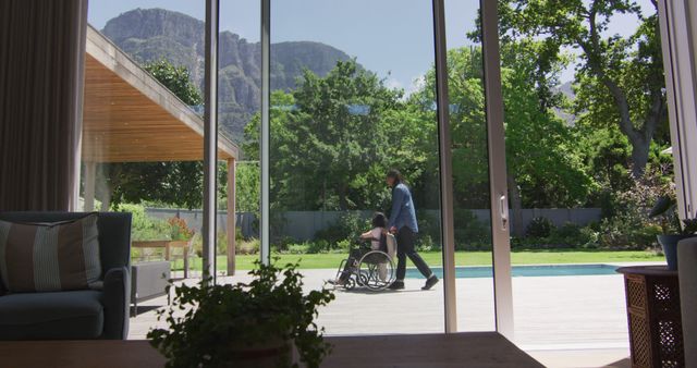 Caring Father Pushing Son in Wheelchair Outside Home - Download Free Stock Images Pikwizard.com