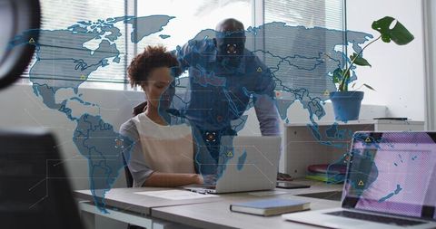 Business Team Collaborating on Global Data Visualization with Laptop and World Map Overlay