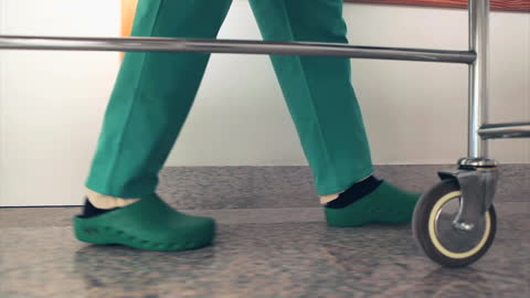 Nurses Transporting Patient in Hospital Corridor