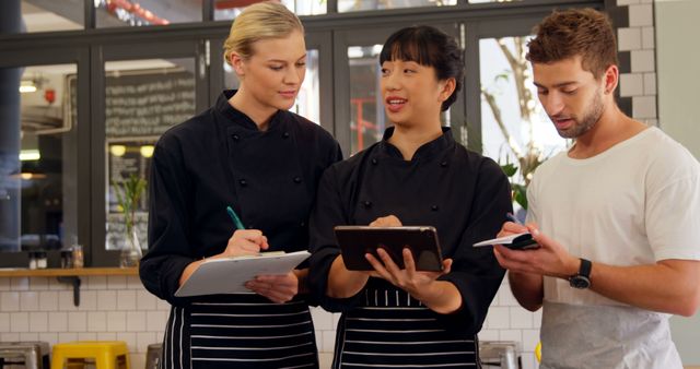 Professional Chefs in Kitchen Discussing Menu and Recipes - Download Free Stock Images Pikwizard.com