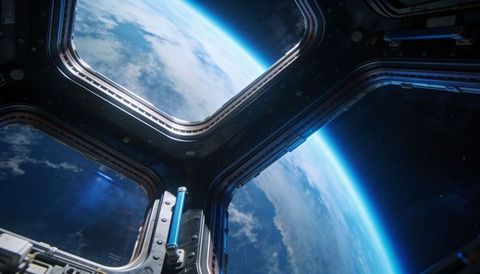 Cupola window view revealing earth curvature from space station interior
